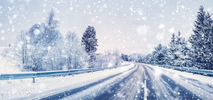 Snowfall on the curvy highway in winter natural park. Blizzard on the country road.