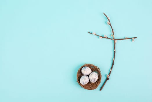 Religious cross made from willow branches, easter nest with eggs, belief, faith and spirituality in religon, resurrection of Jesus Christ, christianity