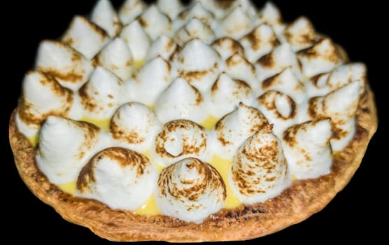Lemon meringue pie over dark background. Selective focus