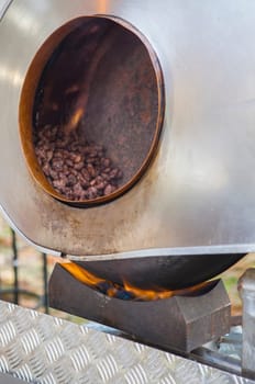 Garrapinadas processing at rotatory pot. Traditional caramel-coated almonds been processed at fair stall