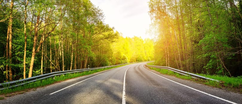 Beautiful background of the asphalt road in spring. Concept of family vacation and trip.
