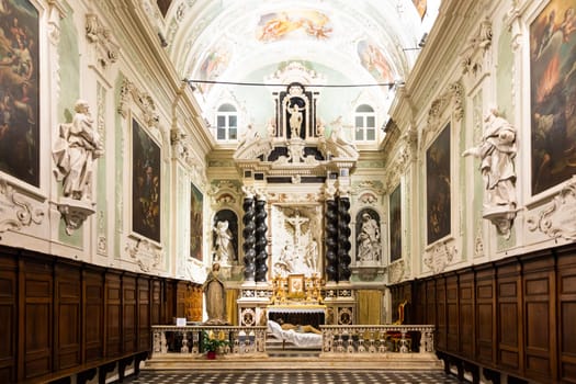 Ventimiglia, Italy - August 2022: the baroque church interior of Oratorio dei Neri with Jesus Christ statue