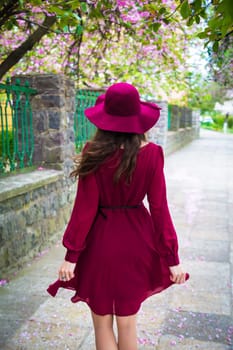 girl in red dress and hat - rear view