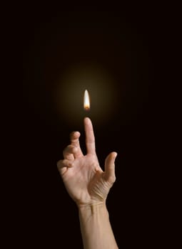 A finger holding a flame. Power and energy concept.