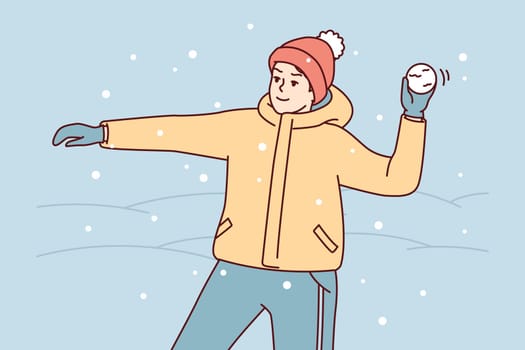 Teenage boy in winter clothes and hat plays snowballs throws snow at friends. Youth guy stands on street among snowdrifts enjoys cold weather and frolic during holidays. Flat vector illustration
