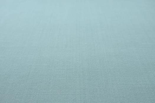 blue gray background fabric texture. A piece of woolen cloth is neatly laid out on the surface. Weave and textile texture. Dress fabric or for kitchen needs, tablecloth or curtains, close-up. Dash.