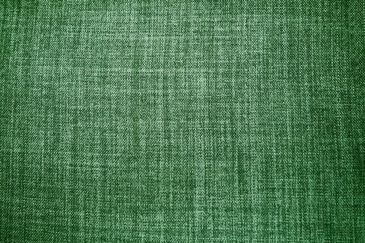 green background fabric texture. A piece of woolen cloth is neatly laid out on the surface. Weave and textile texture. Dress fabric or for kitchen needs, tablecloth or curtains, close-up. Dash.