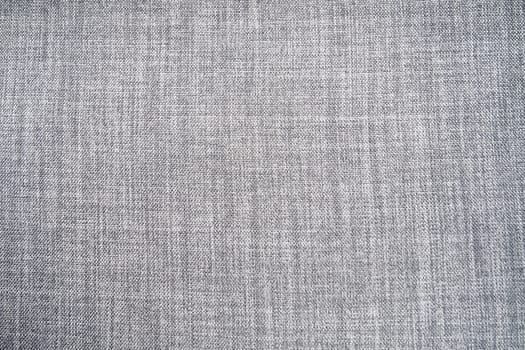 gray background fabric texture. A piece of woolen cloth is neatly laid out on the surface. Weave and textile texture. Dress fabric or for kitchen needs, tablecloth or curtains, close-up. Dash.