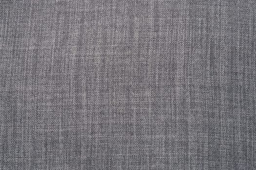 gray background fabric texture. A piece of woolen cloth is neatly laid out on the surface. Weave and textile texture. Dress fabric or for kitchen needs, tablecloth or curtains, close-up. Dash.