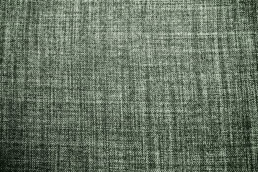 green background fabric texture. A piece of woolen cloth is neatly laid out on the surface. Weave and textile texture. Dress fabric or for kitchen needs, tablecloth or curtains, close-up. Dash.