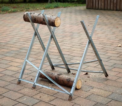 Details of a sawhorse with log and saw at a wedding.