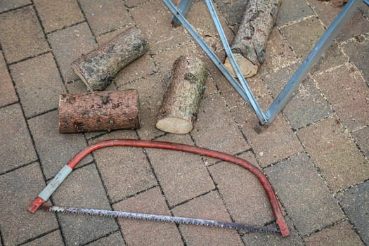 Details of a sawhorse with log and saw at a wedding.