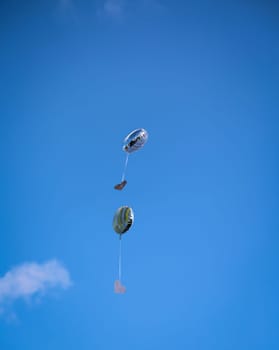 Balloons with greetings and messages rise into the sky at a wedding.