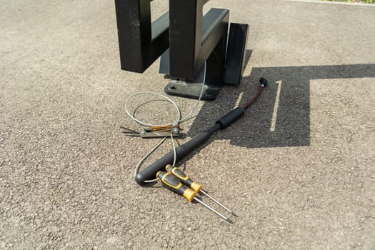 Tools and a pump at a city bike station, sunny day