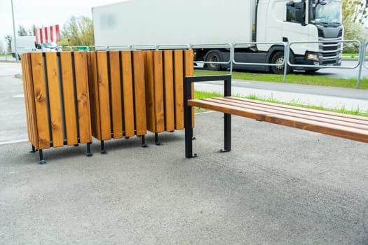 Wooden bench and rubbish bins in urban space.