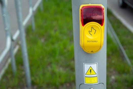 Yellow-red traffic light button touch and wait in Polish language.