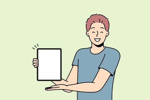Smiling man show mockup screen on tablet