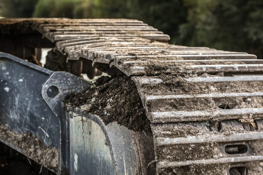 Detail of metal digger track soil left on surface . Construction concept.