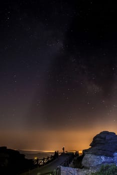 Starry sky background at night in El Torcal de Antequera natural park, Andalusia, Spain. Some of light orange pollution