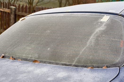 frozen windshield of a passenger car in winter. High quality photo