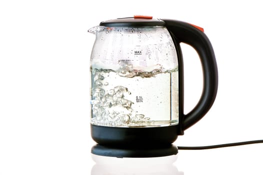 Glass electric kettle with boiling water on a white insulated background. High quality photo