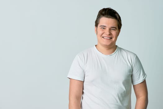 A man on a light background smiles. Emotions. Сopy space. High quality photo