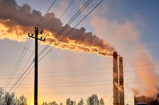 white smoke is coming out of the pipes in the blue sky. High quality photo