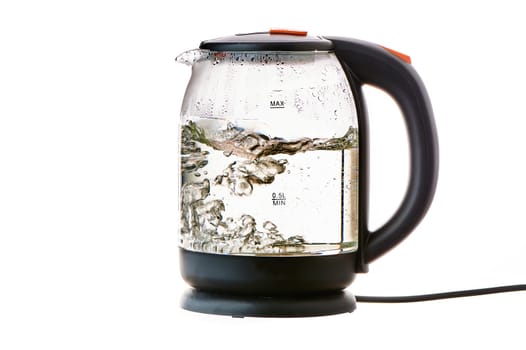 Glass electric kettle with boiling water on a white insulated background. High quality photo