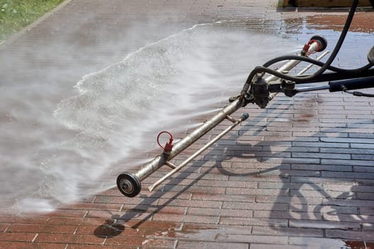 A special machine washes city paths and roads with water. High quality photo