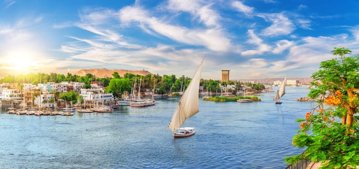 Beautiful Nile scenery of the sailboats and traditional villages of Aswan city, Egypt.