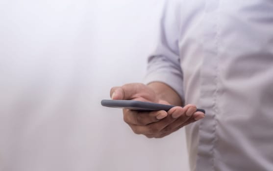 Human using smart phone mobile on blurred background