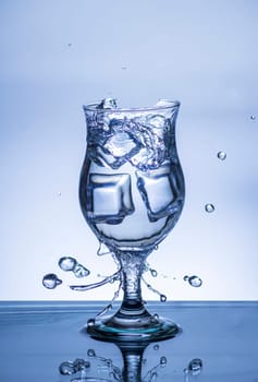 The image of pouring drinking water, into a broken glass, that makes one feel refreshed on blurred white background, Splashing water, Sparkling water, Danger or imminent danger concept