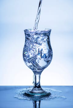 The image of pouring drinking water, into a broken glass, that makes one feel refreshed on blurred white background, Splashing water, Sparkling water, Danger or imminent danger concept
