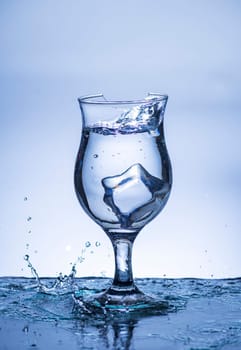 The image of pouring drinking water, into a broken glass, that makes one feel refreshed on blurred white background, Splashing water, Sparkling water, Danger or imminent danger concept