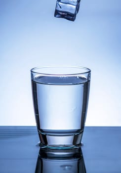 The image of pouring drinking water, into a glass, that makes one feel refreshed on blurred white background, Splashing water, Sparkling water