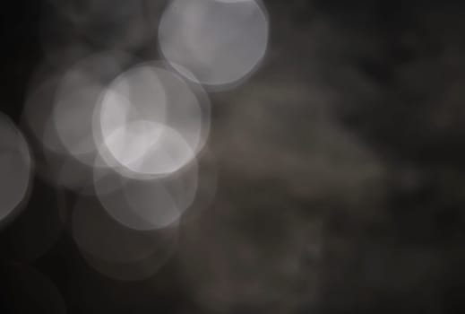 Light abstract dark bokeh christmas circle color glitter blurred black background