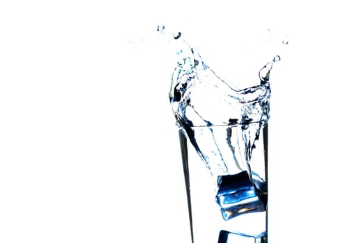 The image of pouring drinking water, into a glass, that makes one feel refreshed on blurred white background, Splashing water, Sparkling water