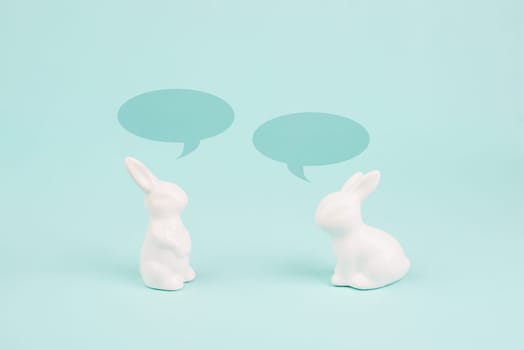 Easter bunny talking together, rabbits have a conversation, spring holiday greeting card with speech bubbles