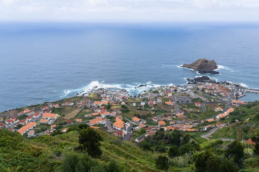 Madeira / Portugal - July 10 2021: Tiny coastal municipality Porto Moniz with its oceanic swimming pools and cozy houses.