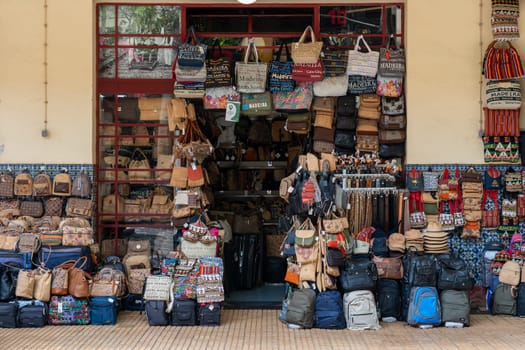 Madeira / Portugal - July 12 2021. Shop selling bags hats and belts at the market area of funchal in madeira