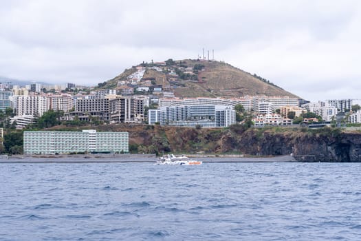 Funchal Madeira Portugal - July 15 2021: Tourists looking for dolphins and whales from a large catamaran