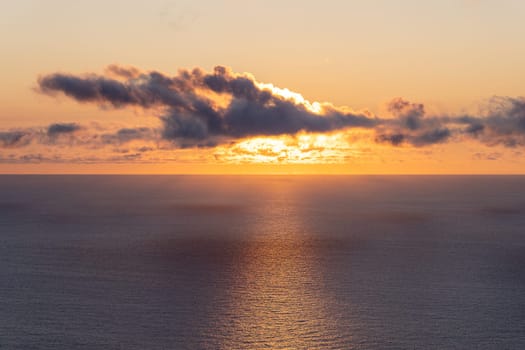 The view to sunset on ocean from mountain in Madeira island.