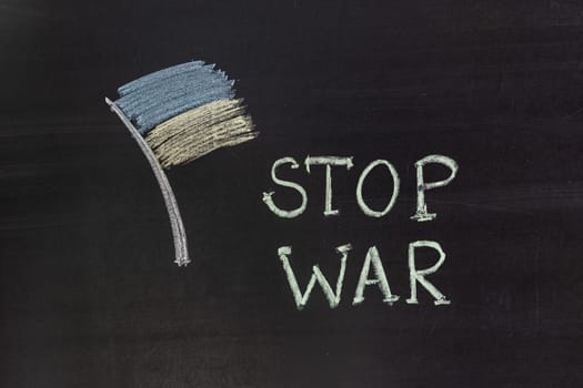 Word "Stop war"" writed on blackboard with chalk"