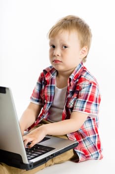 The little boy with a laptop. studio