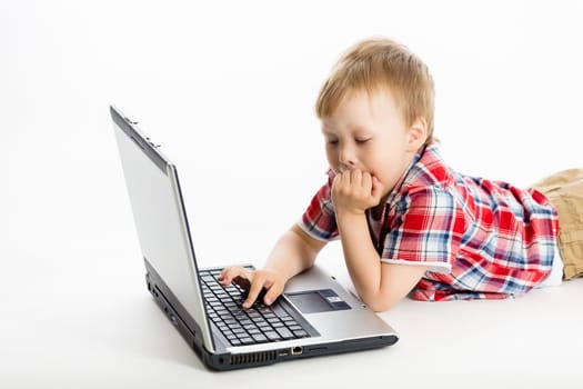 The little boy with a laptop. studio