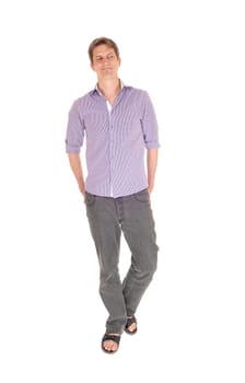 A young man in jeans and a purple shirt standing relaxed isolated.for white background..