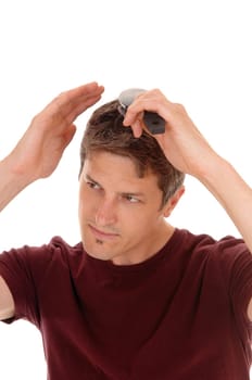 A handsome young man in a burgundy shirt brushing his hair,.isolated for white background..