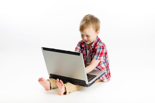 The little boy with a laptop. studio
