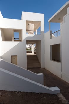 The small part of the white facade of the building in Egypt. side view on ladder