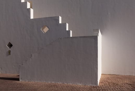 The small part of the white facade of the building in Egypt. side view